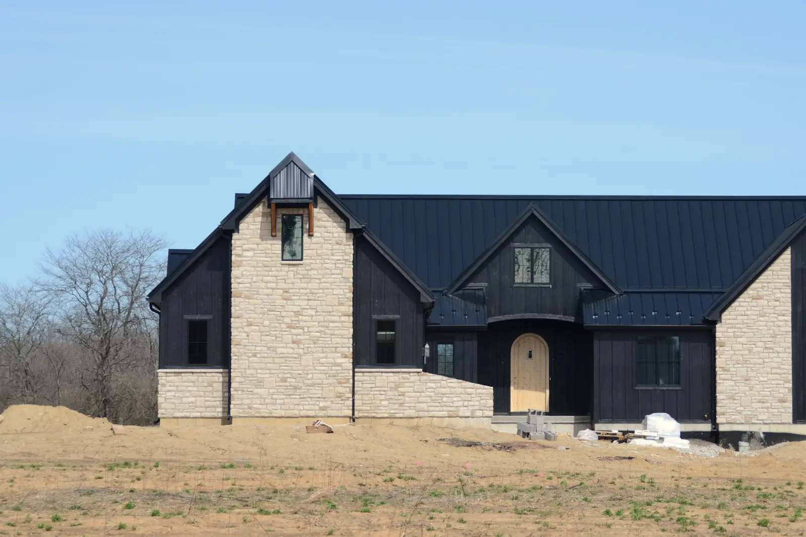 New dark-sided home with stone accents just after completion
