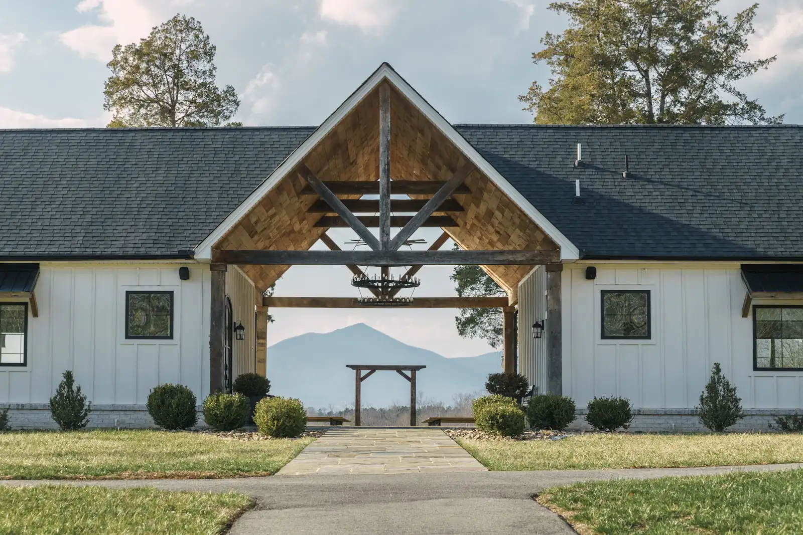 White board-and-batten modern farmhouse with a timber entry